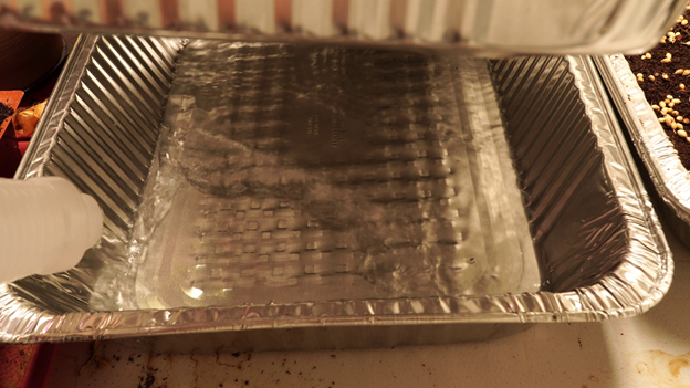 Filling bottom tray with water